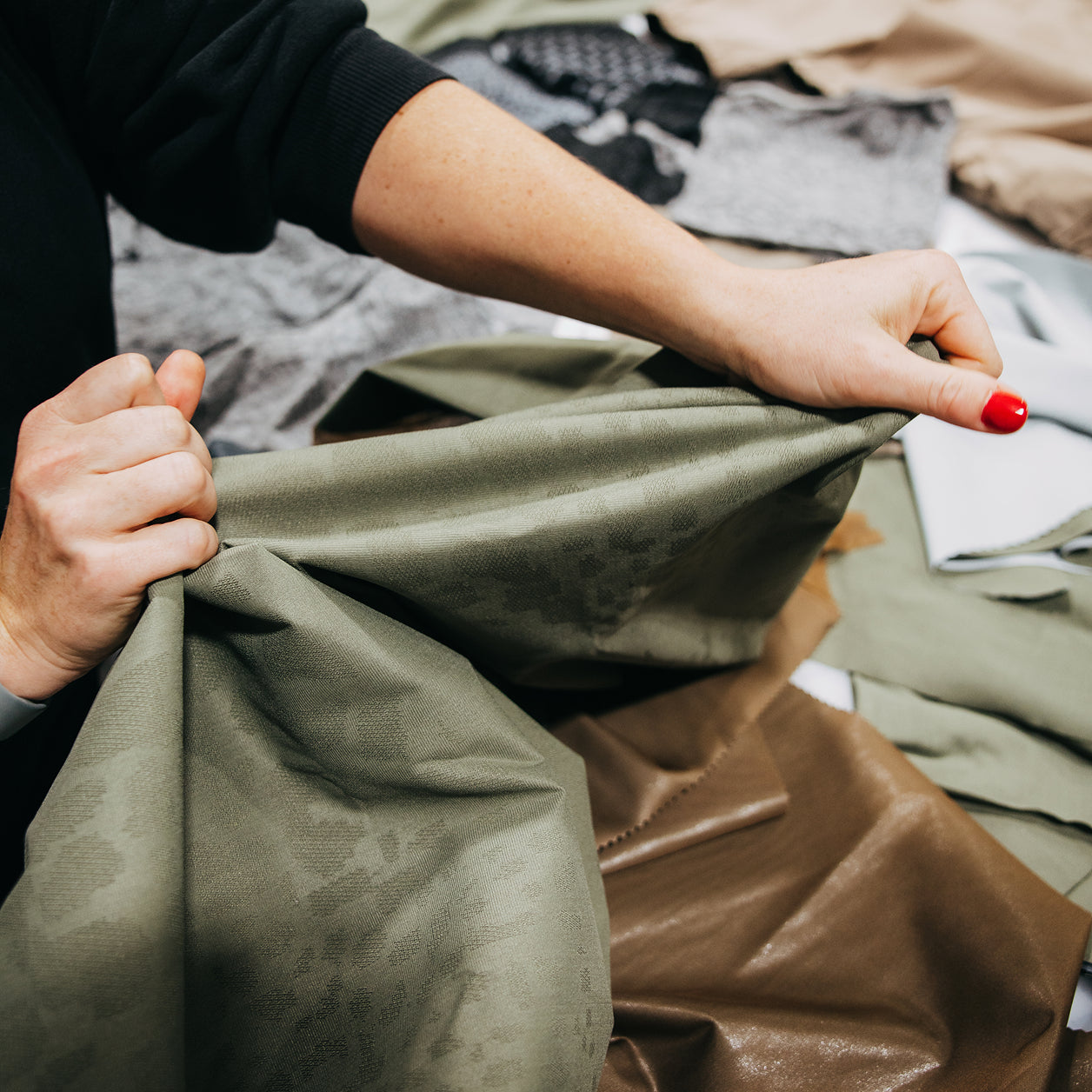 person stretching outerwear fabric
