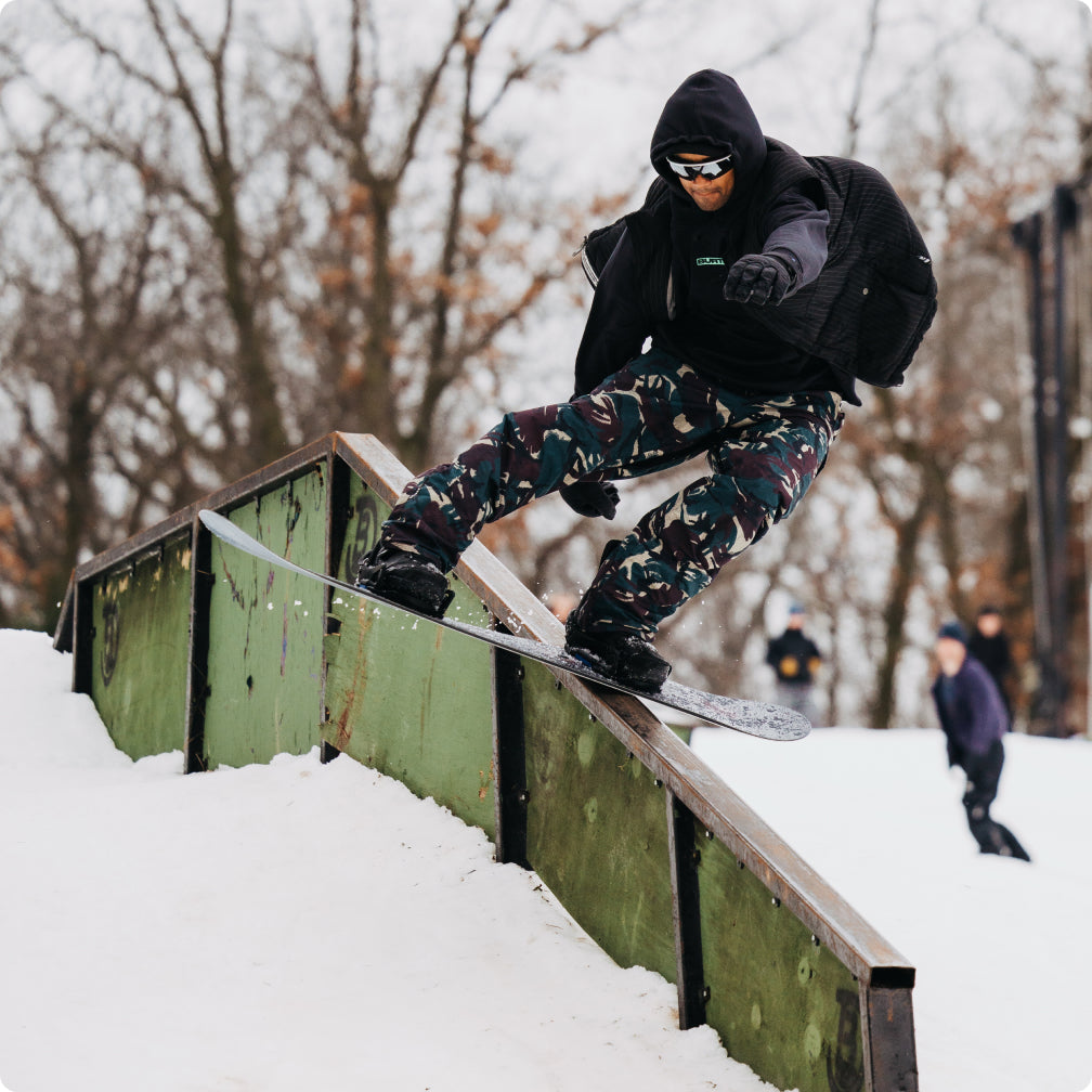Rob Roethler boardsliding a rail on his snowboard with Step On boots and bindings.