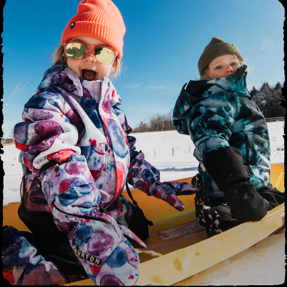 Kids playing in Burton One Piece Outerwear and beanie