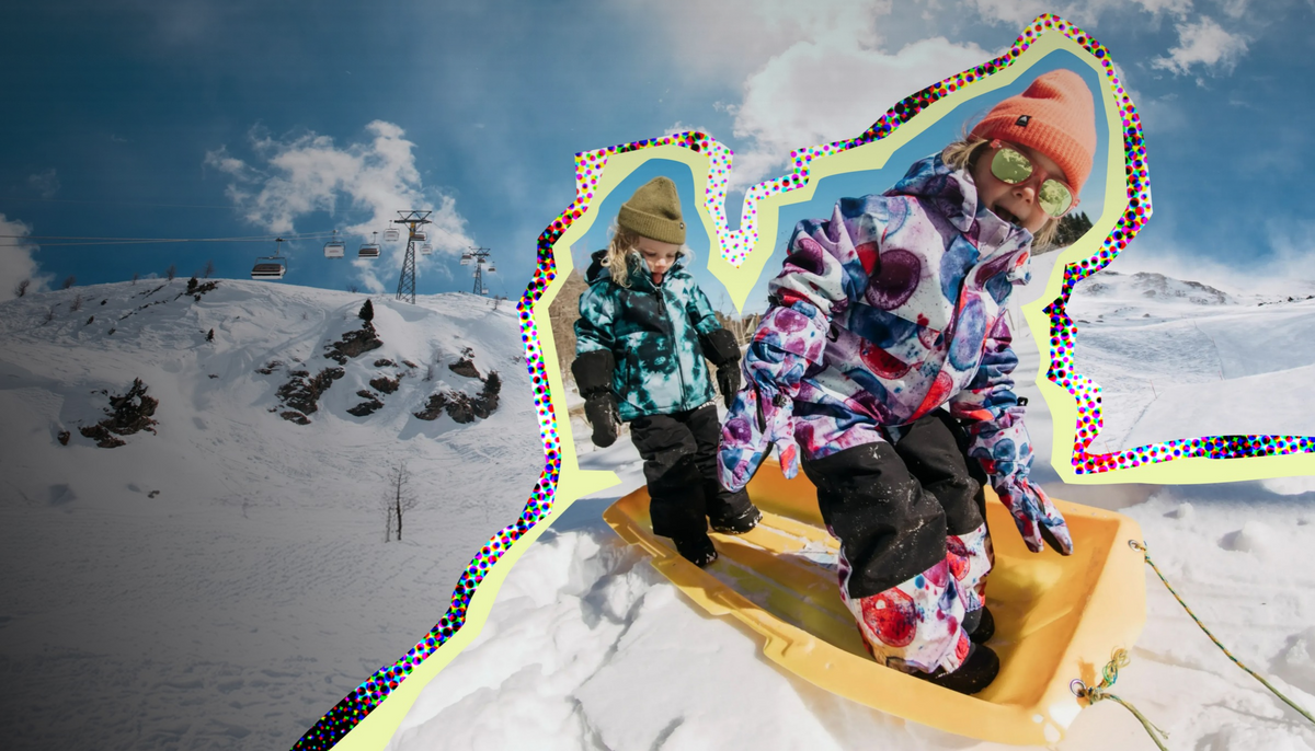 Two kids wearing Burton outerwear and beanies standing on a yellow sled in the snow.