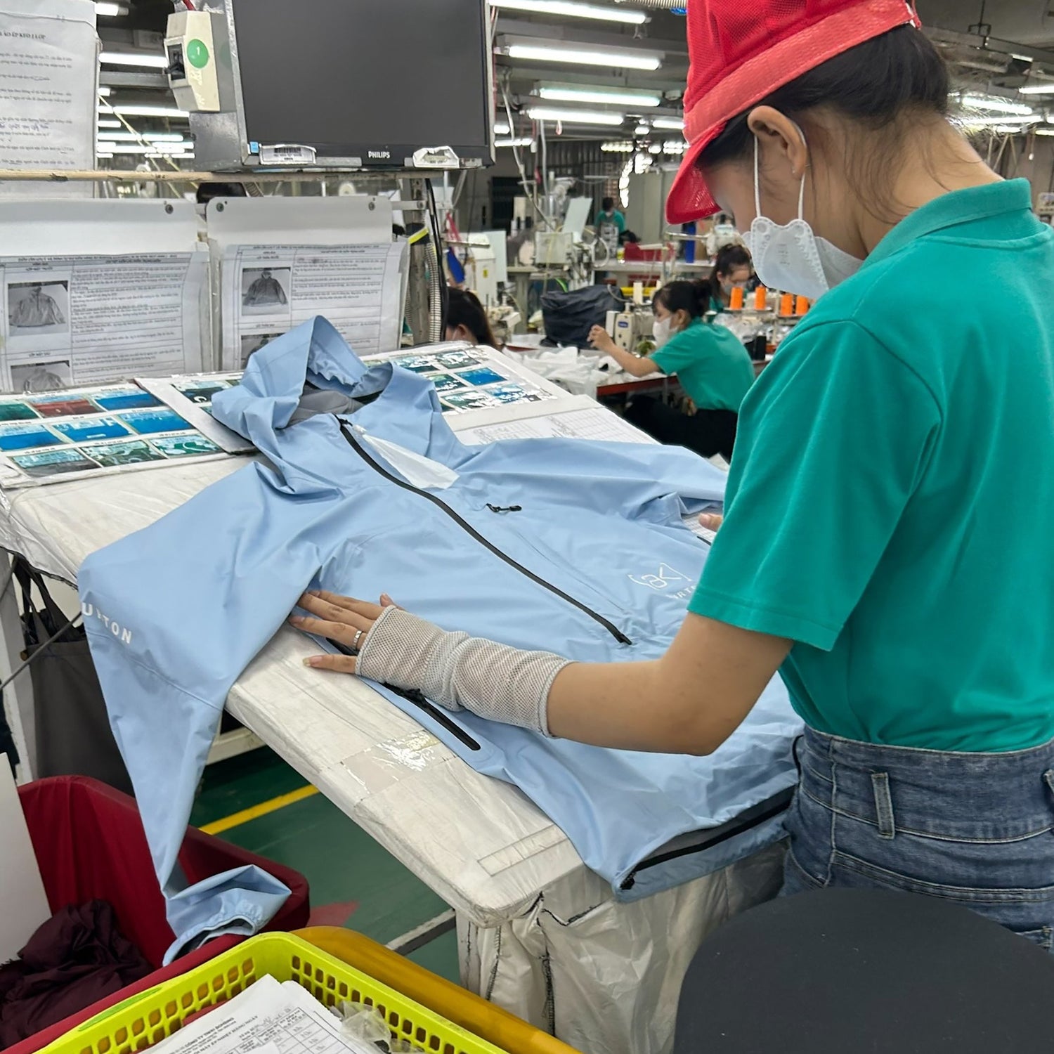 Factory employee working on a Burton [ak] Jacket