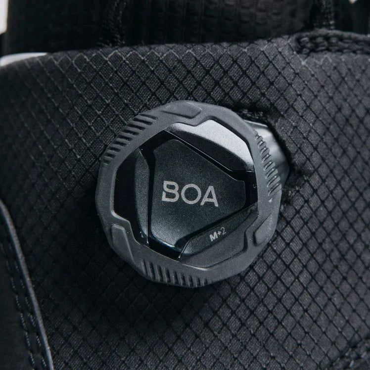Close-up of a BOA system knob on a black boot