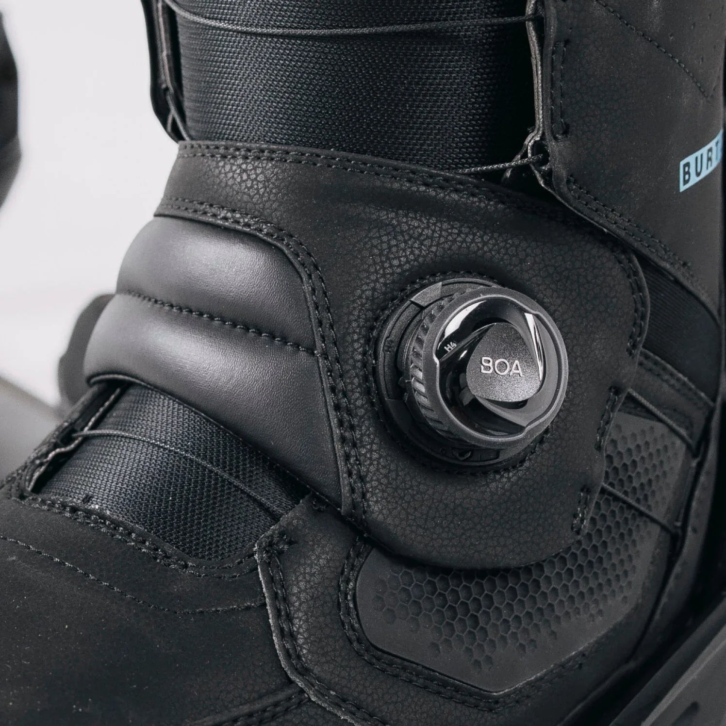 Close-up of a black boot with BOA system mechanism on a white background